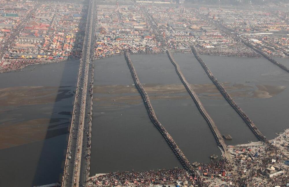 Pontoon bridges connecting the river banks and people at Prayag Kumbh, 2019. 22 such pontoon bridges were constructed to get people, animals and vehicles across rivers. 